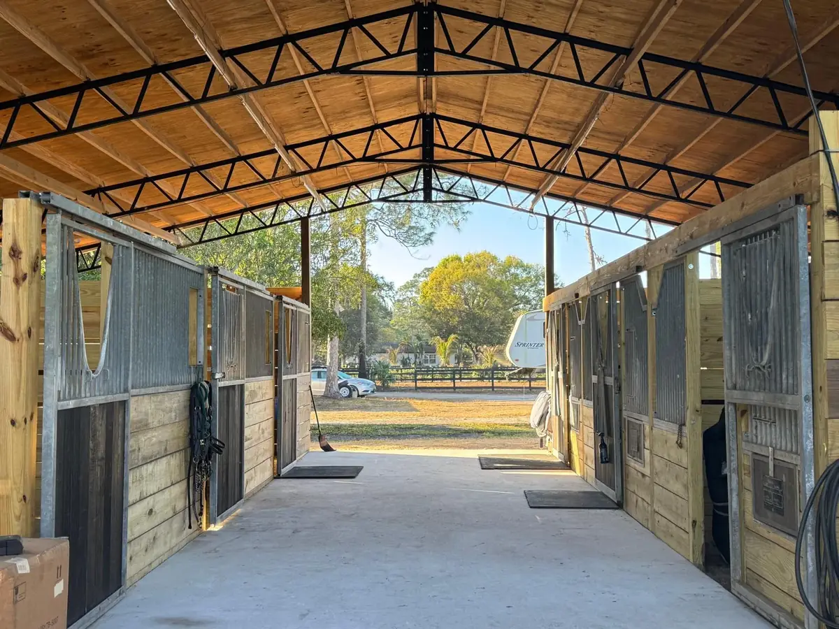 Covered barn aisle with stalls on both sides